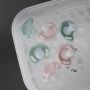 Close up of pacifiers inside an open SteriDryer against a grey background