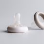 Breast-like soothers on a grey background