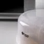 Close up of a microwave steriliser on a kitchen worktop with a microwave in the background