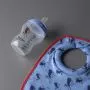 Milk bib and Natural Start bottle laid out against a dark grey background