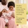 Parent assembling their cord-free breast pump while holding baby.