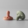 Breast-like soothers on a light grey background.