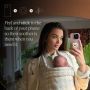 Amy Jackson with baby, holding phone with StayPut Pocket™ attached.