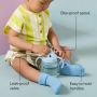 Toddler sat on the floor holding a Starter Spout cup with pointers to the product key features