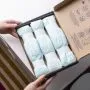 Image of someone holding an open box of Twist & Click refills on a changing table
