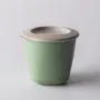 Pop up weaning pot on a grey background