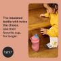 Toddler kneeling down and reaching for an Insulated Sporty Spout and Straw Cup with text overlay of product USP and icon of 12 months+
