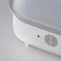 Close up of the buttons on the front of a steam steriliser against a grey background