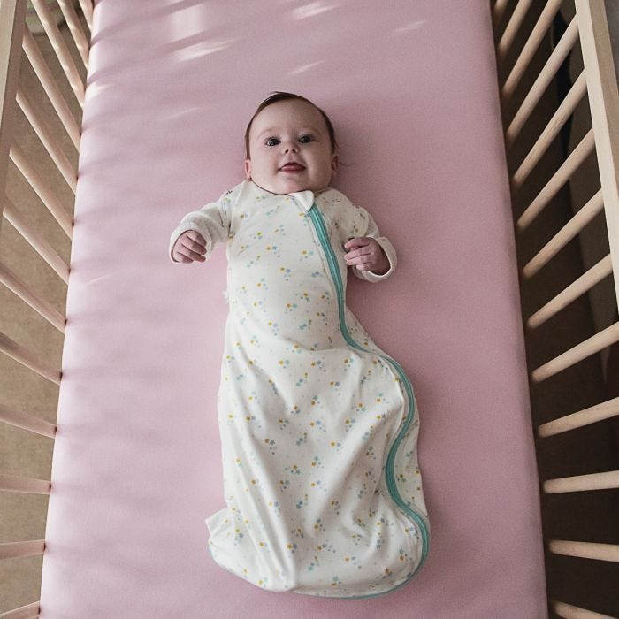 Baby in cot wearing The Original Grobag Baby Stars Snuggle