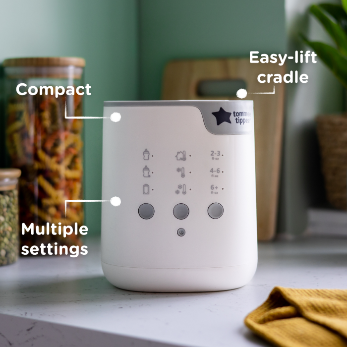 Bottle warmer on kitchen counter with pointers to its compact design, multiple settings and easy-lift cradle