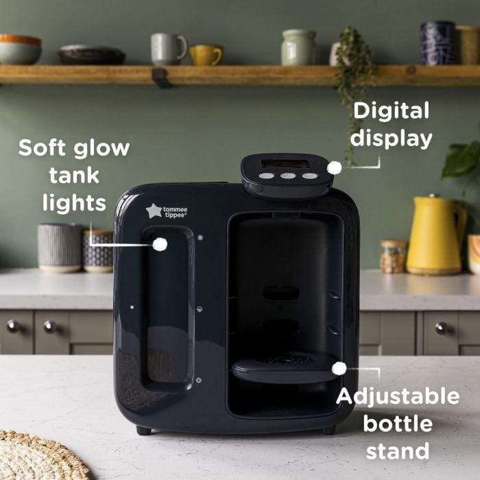 Black Perfect Prep machine on kitchen counter with pointers to its tank lights, digital display and adjustable bottle stand