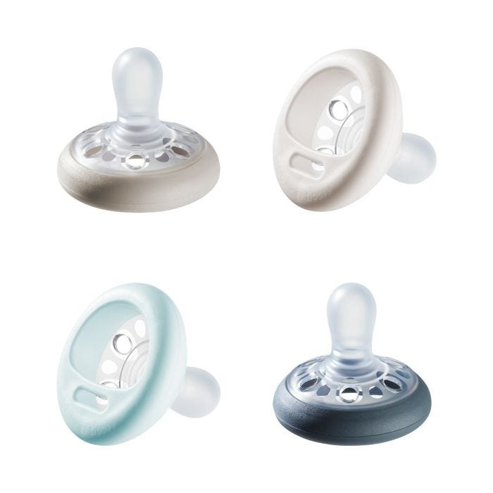 4 pack of Breast-like pacifier in various colours on a white background.