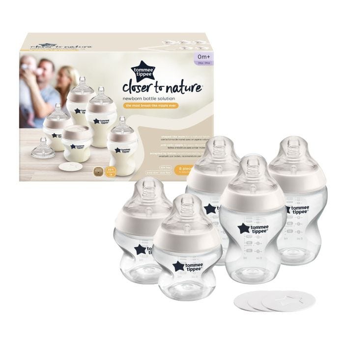 First Bottle Solution baby bottle set next to packaging on white background.