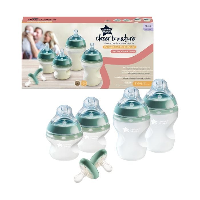 Silicone Bottle and Breast-like Pacifier Set next to packaging on white background.