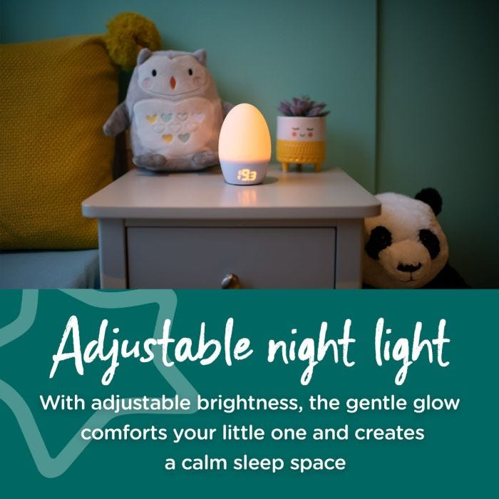 Groegg2 illuminated yellow on bedside table with text stating that it is adjustable