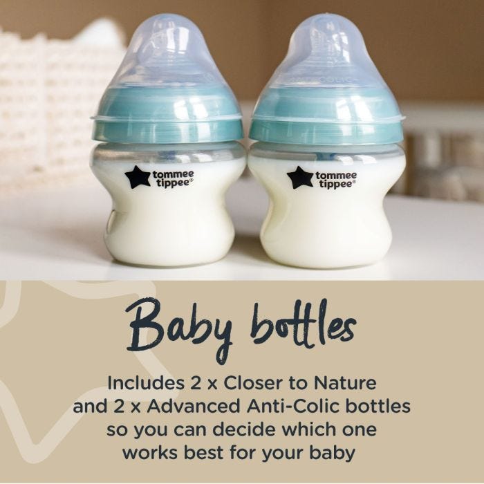 Two anti-colic baby bottles on kitchen counter with text about how the kit includes 4 baby bottles