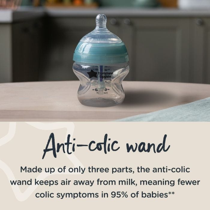 Advanced Anti-Colic baby bottle on a kitchen counter with text about the anti-colic wand