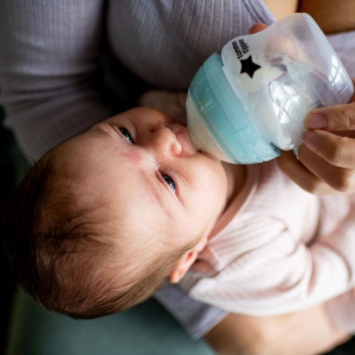 Baby drinking from a 150ml Closer to Nature Anti-Colic baby bottle.