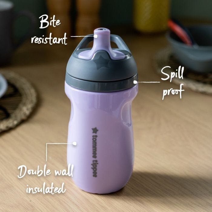 Purple sportee bottle on a kitchen table with pointers to its bite resistant spout, insulated base and spill proof lid