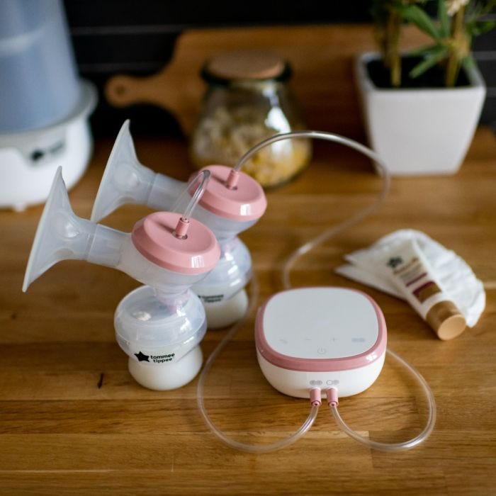 Double electric breast pump with nipple cream on table