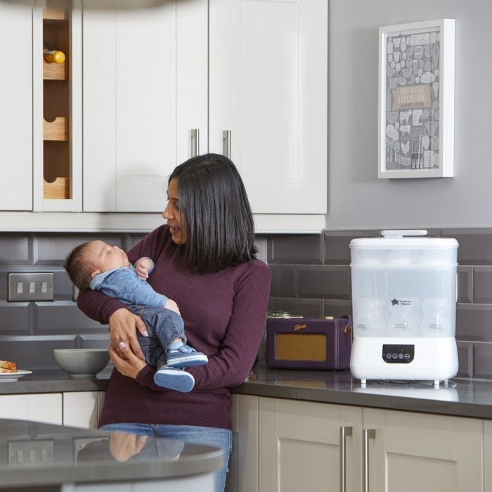 Mother with baby and steriliser in the background 