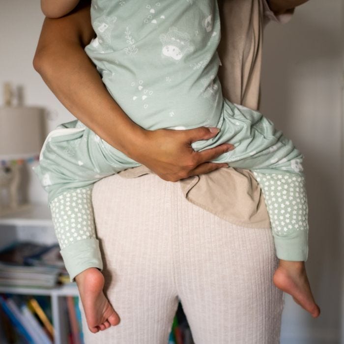 Mum holding child wearing The orignial grobag steppee