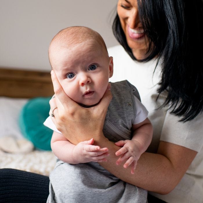 mum holding baby swaddle in The Original Grobag Swaddlebag
