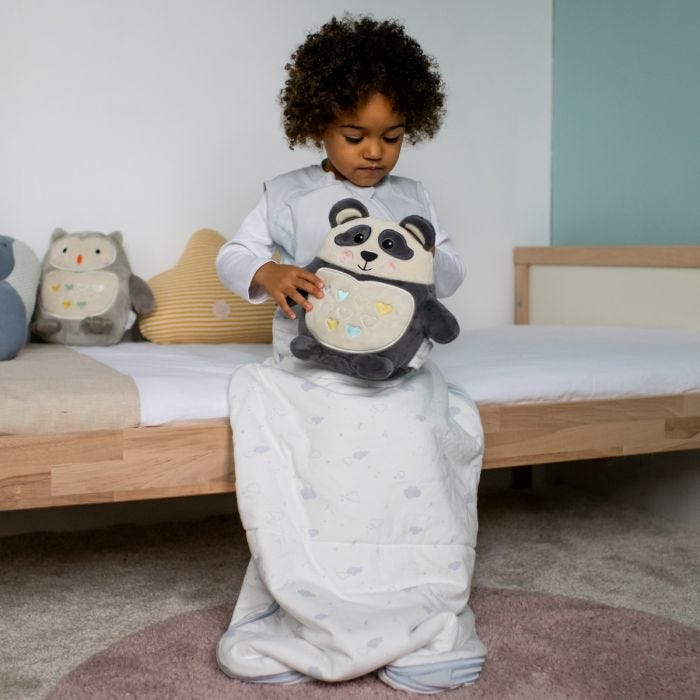 Child in All-Season Grobag holding Grofriend Light & Sound Sleep Aid