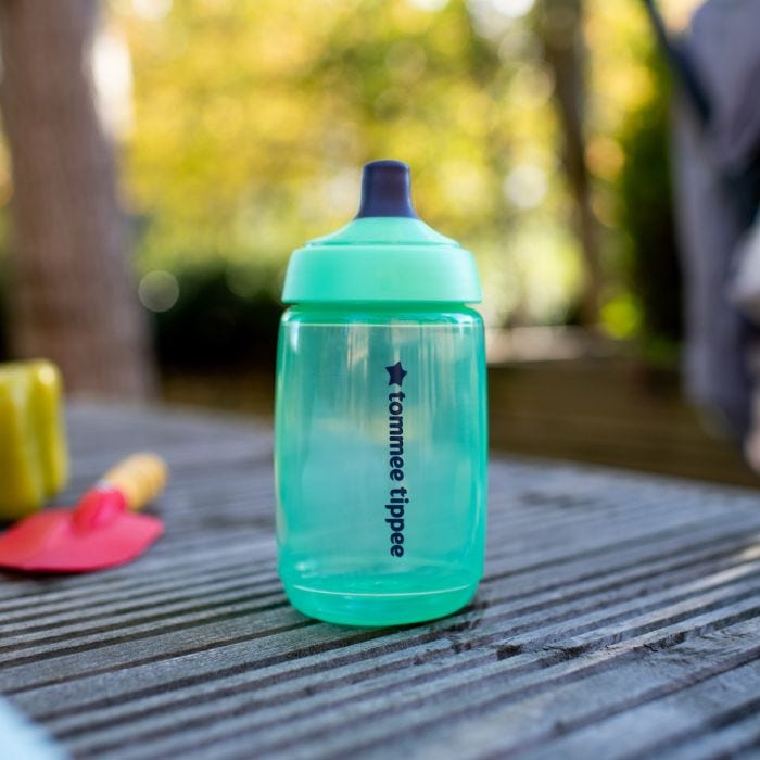 Sportee Water Bottle in Green placed upright on wooden decking in the garden