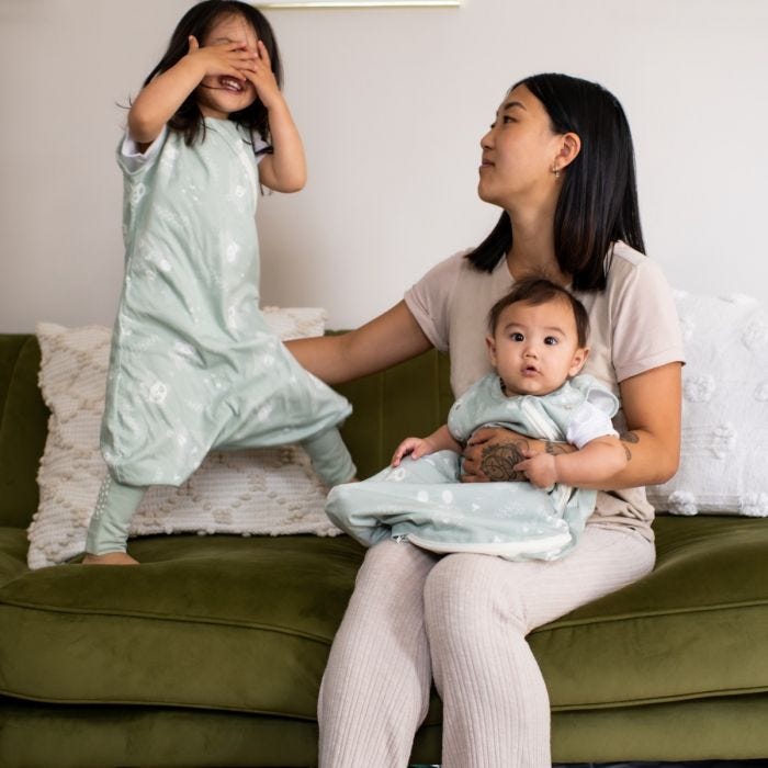 Mum holding child wearing The orignial grobag steppee 