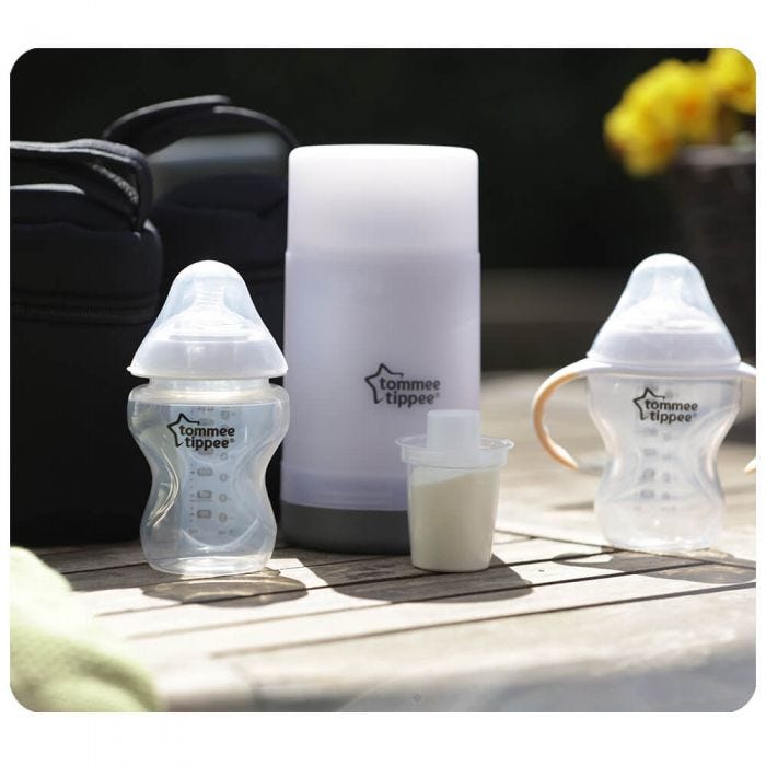 Travel Bottle and Food Warmer pictured on bench with 2 Tommee Tippee bottles