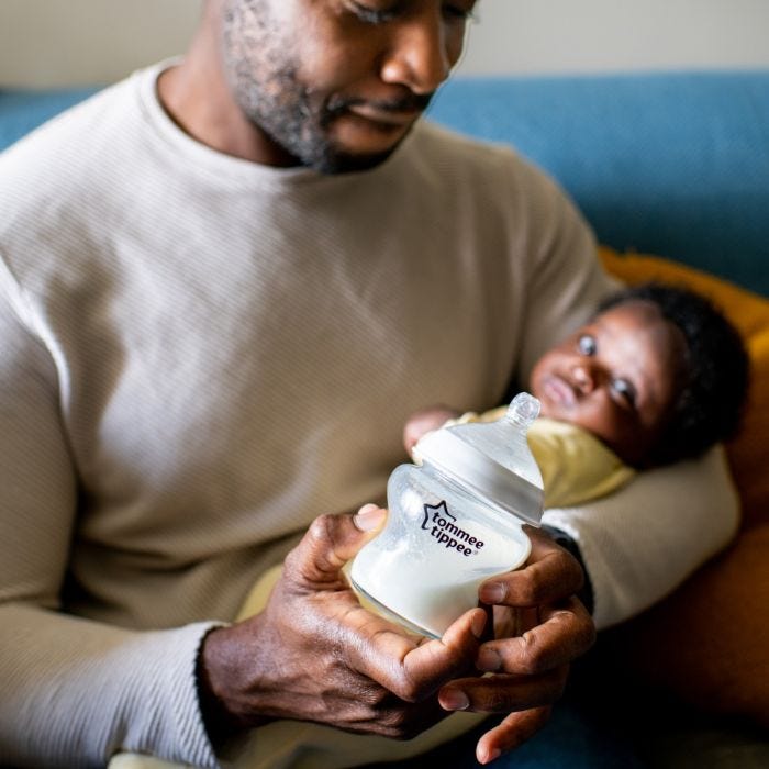 Father holding baby and Closer to Nature bottle