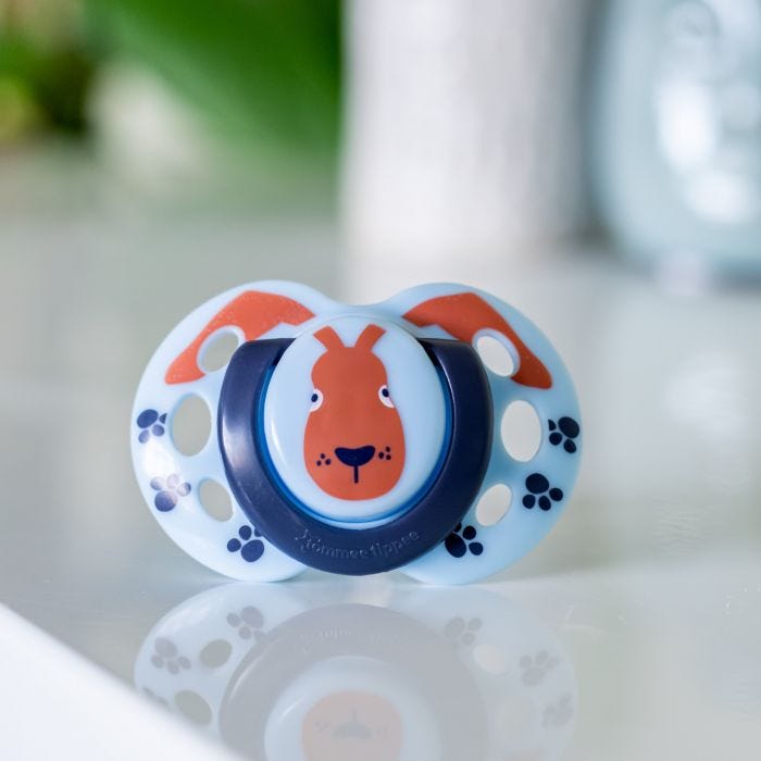 Green Fun Style soother with a fox design, on a white table.