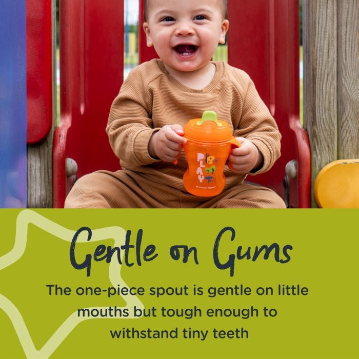 Little boy laughing while holding a green trainer sippee cup with text about how it’s gentle on gums