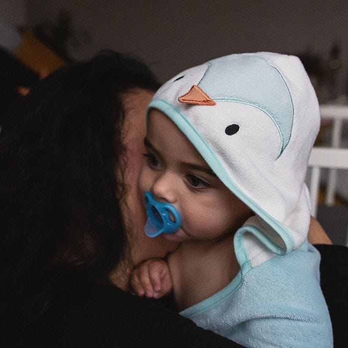 baby wrapped up with Splashtime hug ‘n’ dry hooded towel 