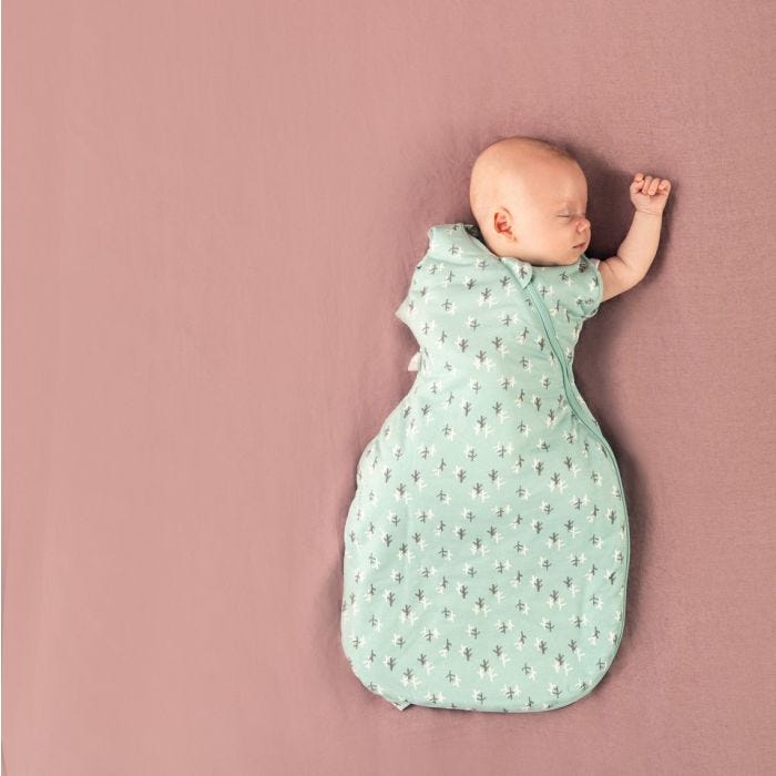baby wearing Tommee Tippee treasure trees snuggle with arm raised