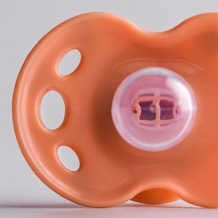 Close up of pacifier on a grey background