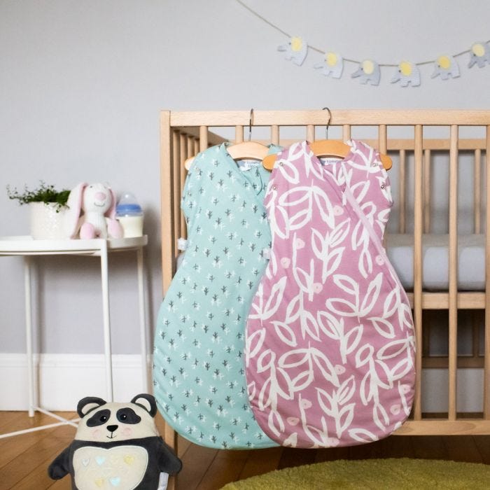 The Original Grobag Botanical and Treasure Snuggle hanging on side of baby cot