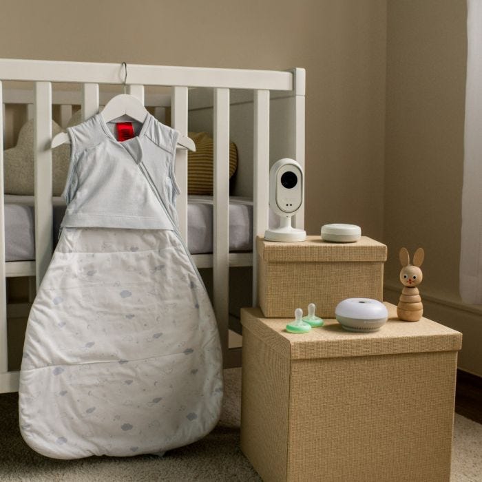 Photo of what’s included in the Dreamsense sleep monitoring bundle taken in a baby’s nursery next to their cot. 