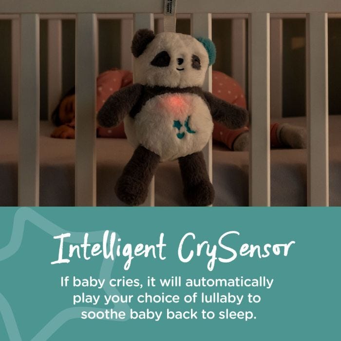 Panda sleep friend attached to cot next to sleeping baby stating that it has an intelligent crysensor.
