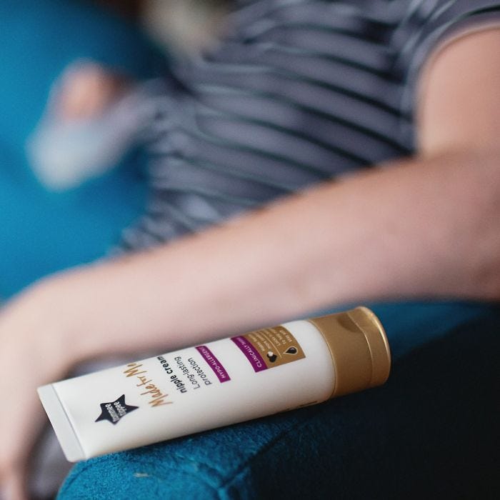 Nipple cream lying flat on someone’s knee