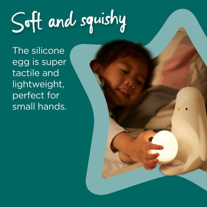  Child holding the removable egg while it is illuminated with text explaining that it is soft and squishy.