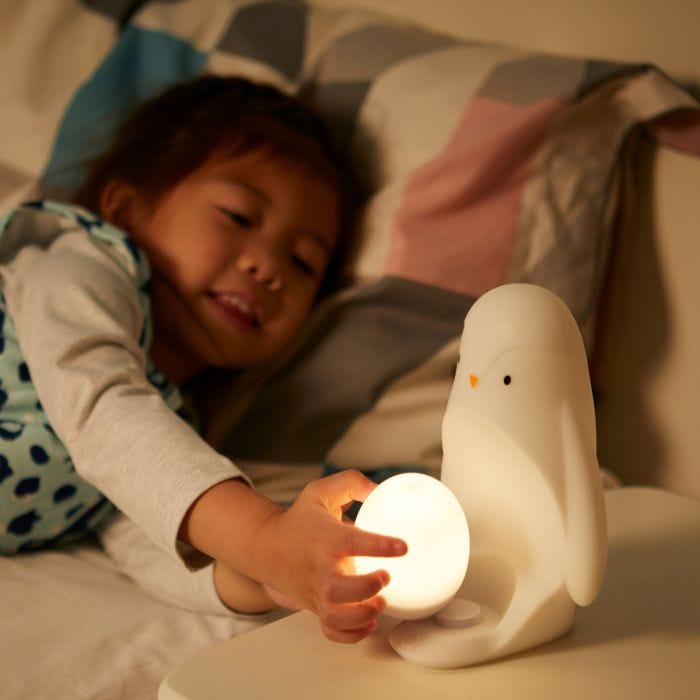 Child holding the removable egg while it is illuminated.