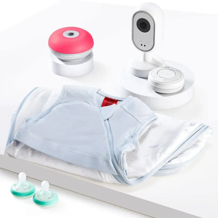 Photo of the contents of the Dreamsense bundle. Including a baby monitor, Dreammaker, soothers and a baby sleep bag. 