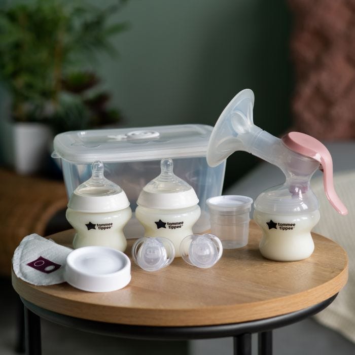 All components of the Breastfeeding Starter Kit placed on a bedside table