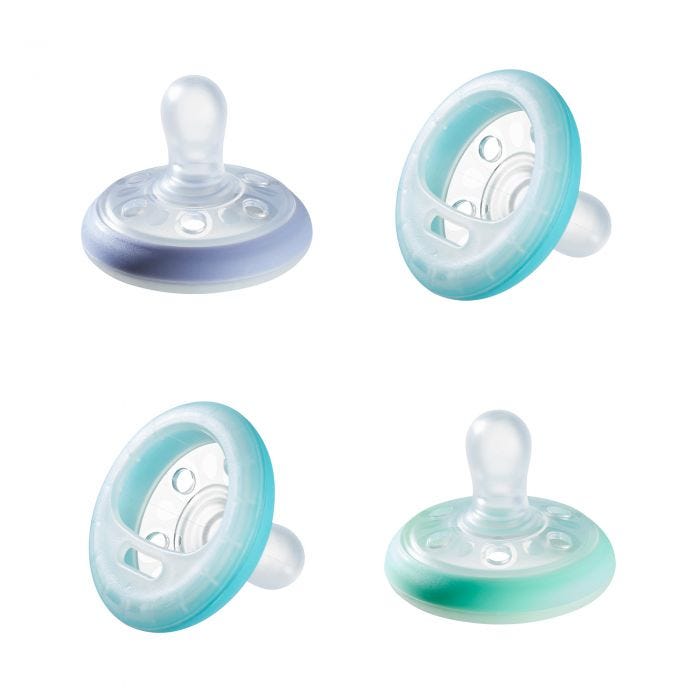 4 pack of Breast-like soothers in various colours on a white background.