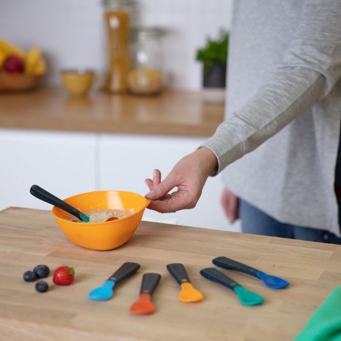 Easigrip™ self feeding spoons layed out on kitchen bench