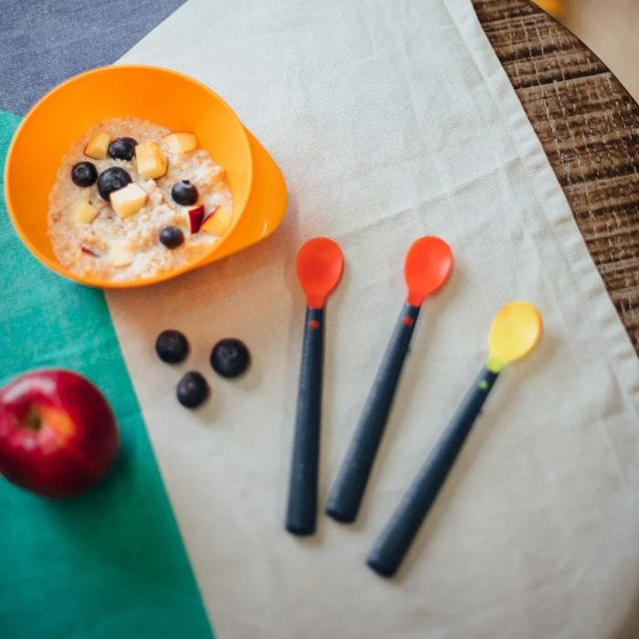 Heat sensing spoons with a bowl of porridge on table