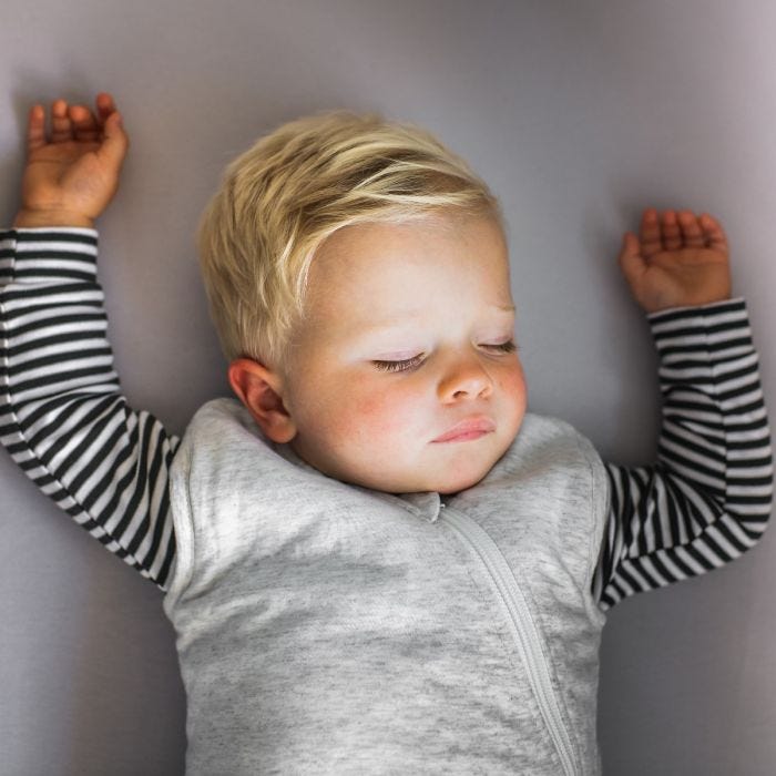 Child sleeping in The Original Grobag Grey Marl Sleepbag