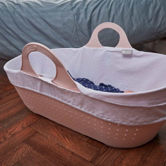 pink moses basket on floor